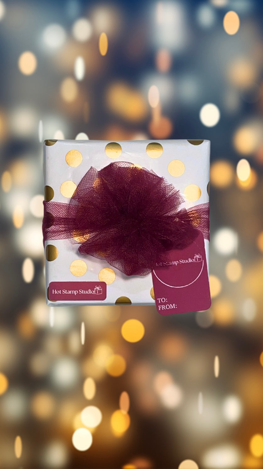 Personalized gift wrapped in decorative paper and adorned with a ribbon bow, perfect for special occasions and gift-giving