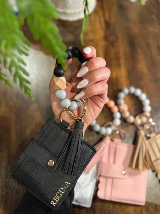 Personalized wallet with silicone beaded wristlet. Customizable with name or initials in gold hot stamped letters in all caps.