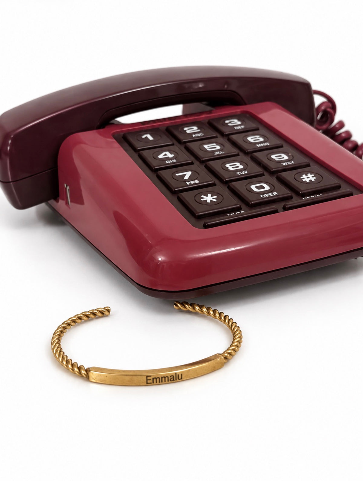 Gold personalized Gilded Cuff bracelet styled beside burgundy vintage phone