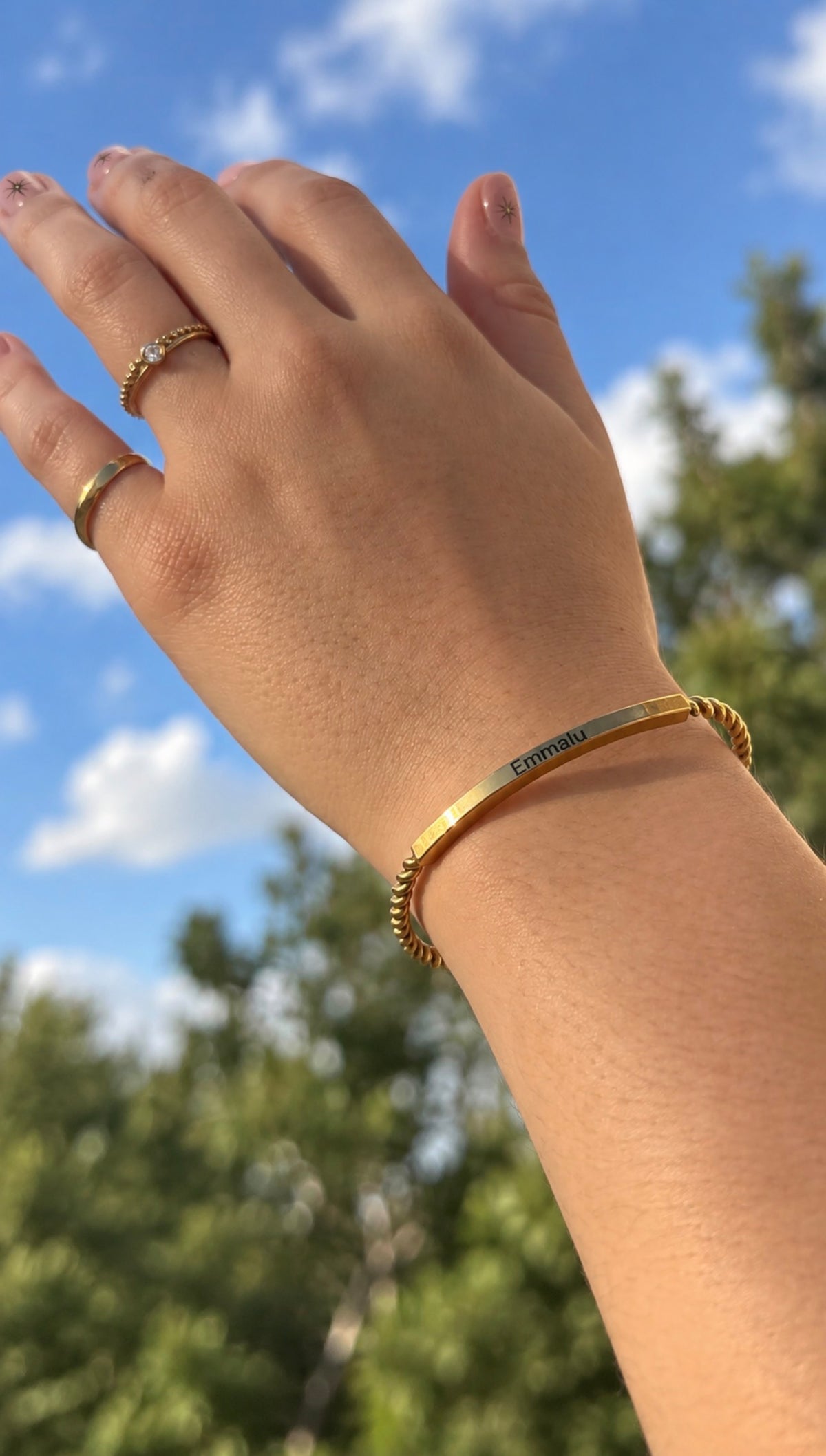 Personalized Gilded Cuff bracelet worn on wrist with custom name engraving