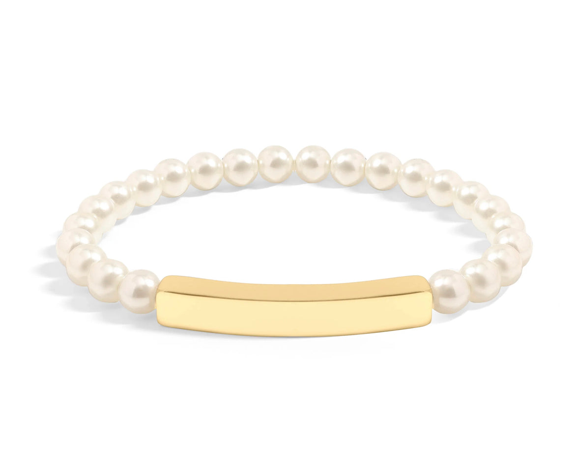 Pearl bracelet with a blank gold bar sitting on a white background.